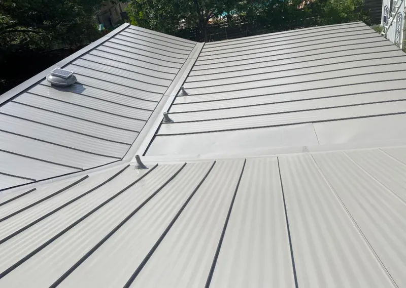 Solar attic fan installed on a metal roof for Roof Ventilation in South Beloit